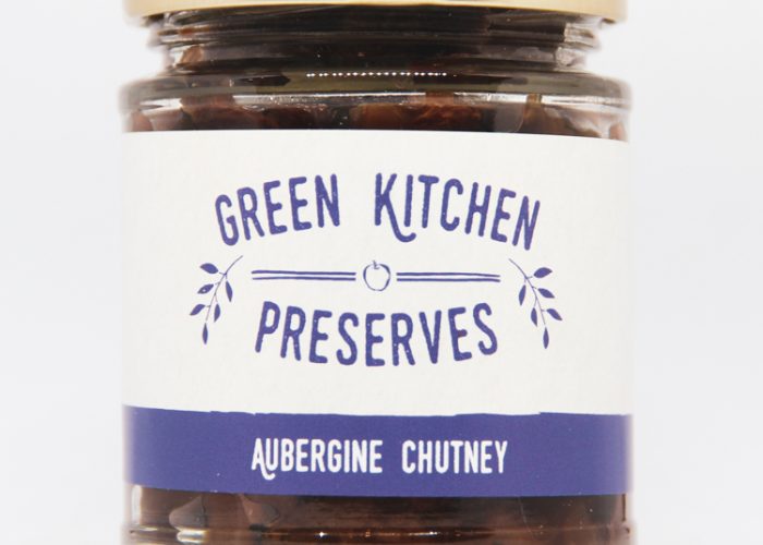 a jar of aubergine chutney on a white background