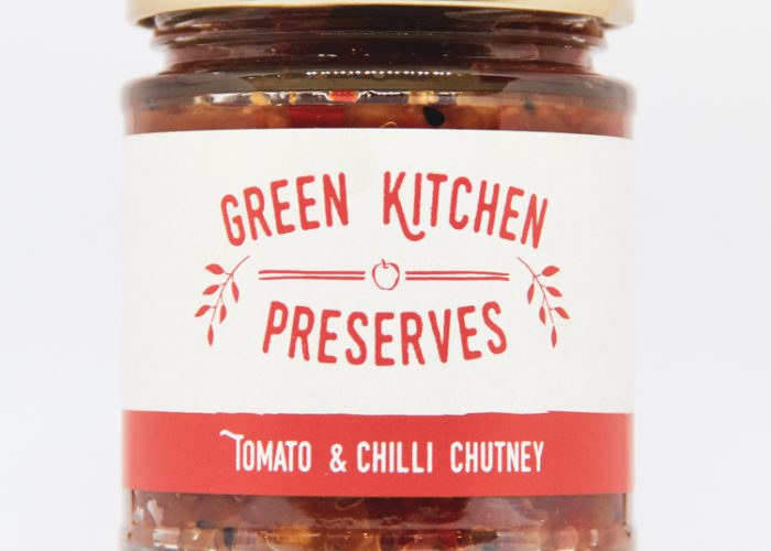 a jar of tomato & chilli chutney on a white background